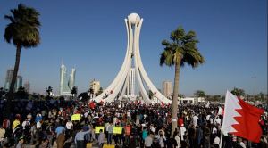 Demonstrators at the Pearl Roundabout before they were attacked and the monument bulldozed
